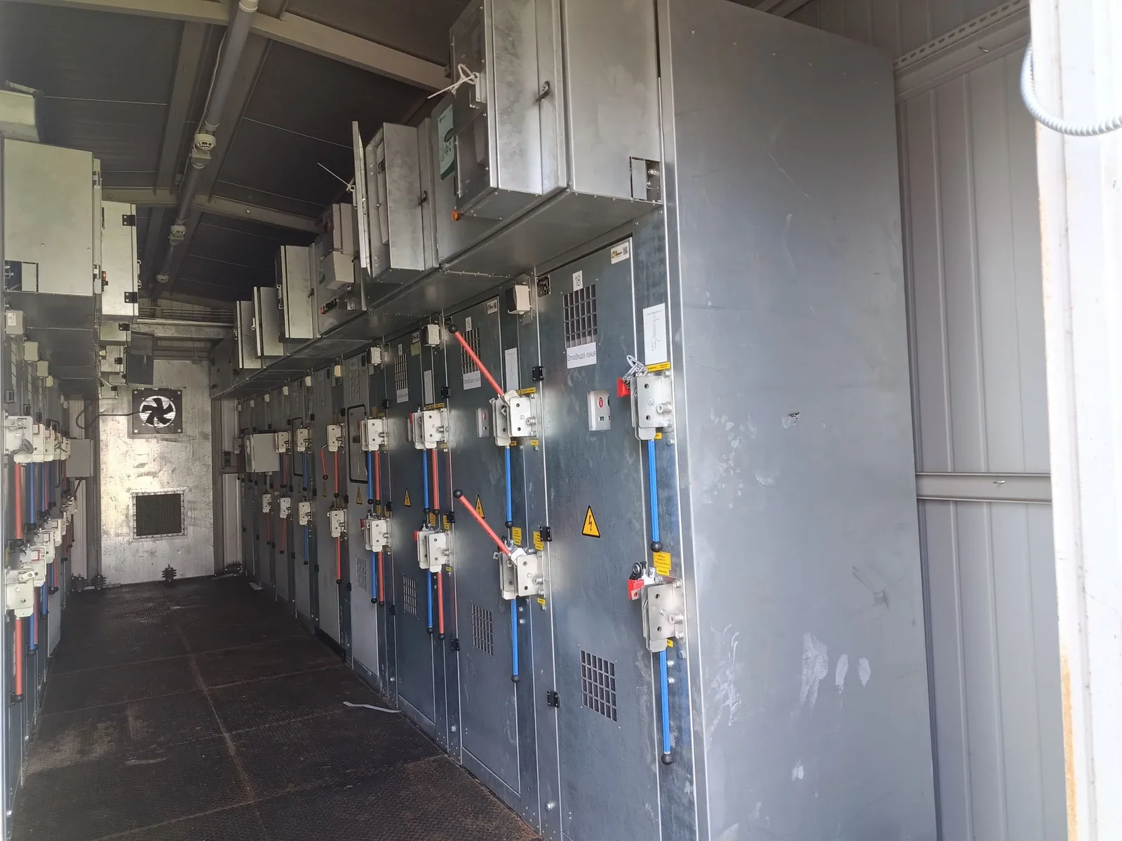 Row of cubicles along the walkway, cable routes along the ceiling