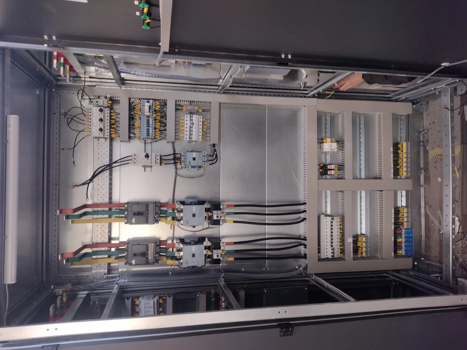Control cabinet with the doors open: contactors, motor protection breakers and terminal blocks