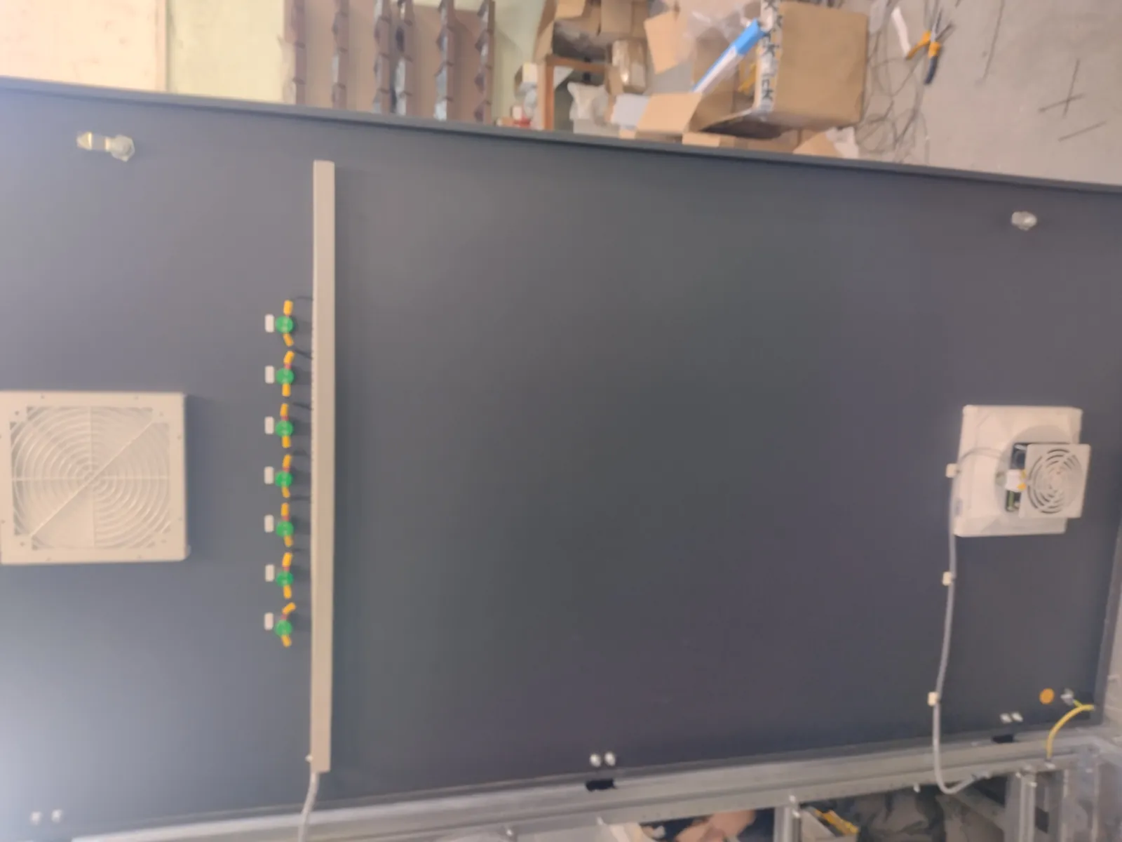 Cabinet door from the inside: a row of indicator lamps, a ventilation grille and a fan