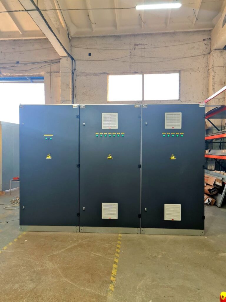 Three equipment cabinets with ventilation grilles and indicator lamps in the workshop
