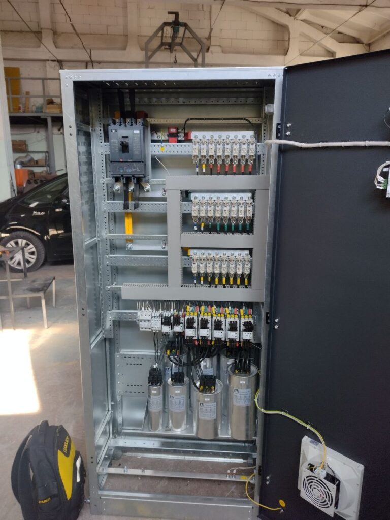 Capacitor bank assembly in a floor-standing cabinet with fuses, contactors and capacitors