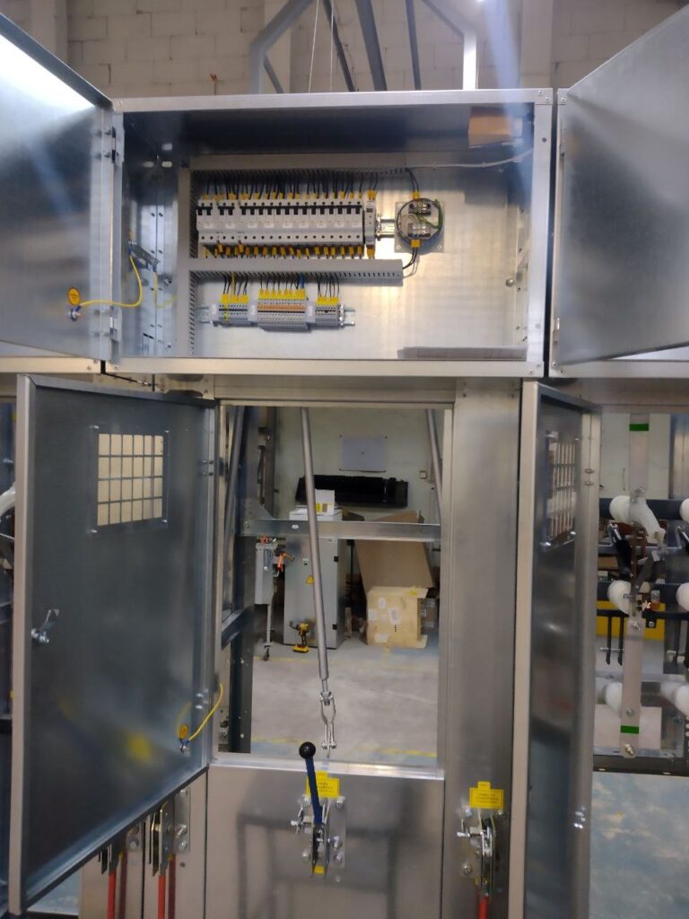 Multi-section switchgear cabinet with secondary circuit compartment during workshop assembly