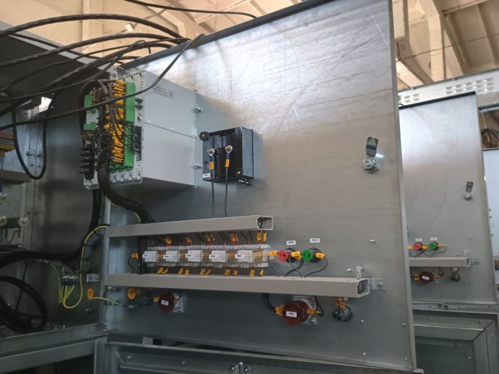 Mounting plate of automation cabinet with terminal blocks, relays and wiring ducts