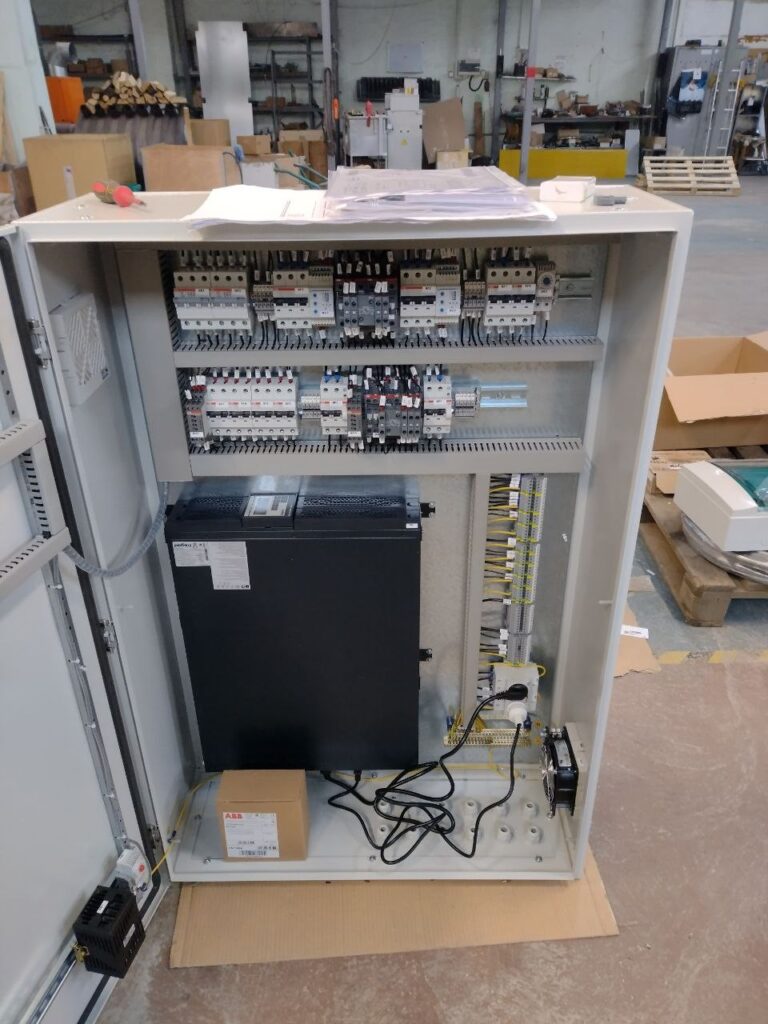 Low-voltage 0.4 kV control cabinet with contactors and modular devices during assembly