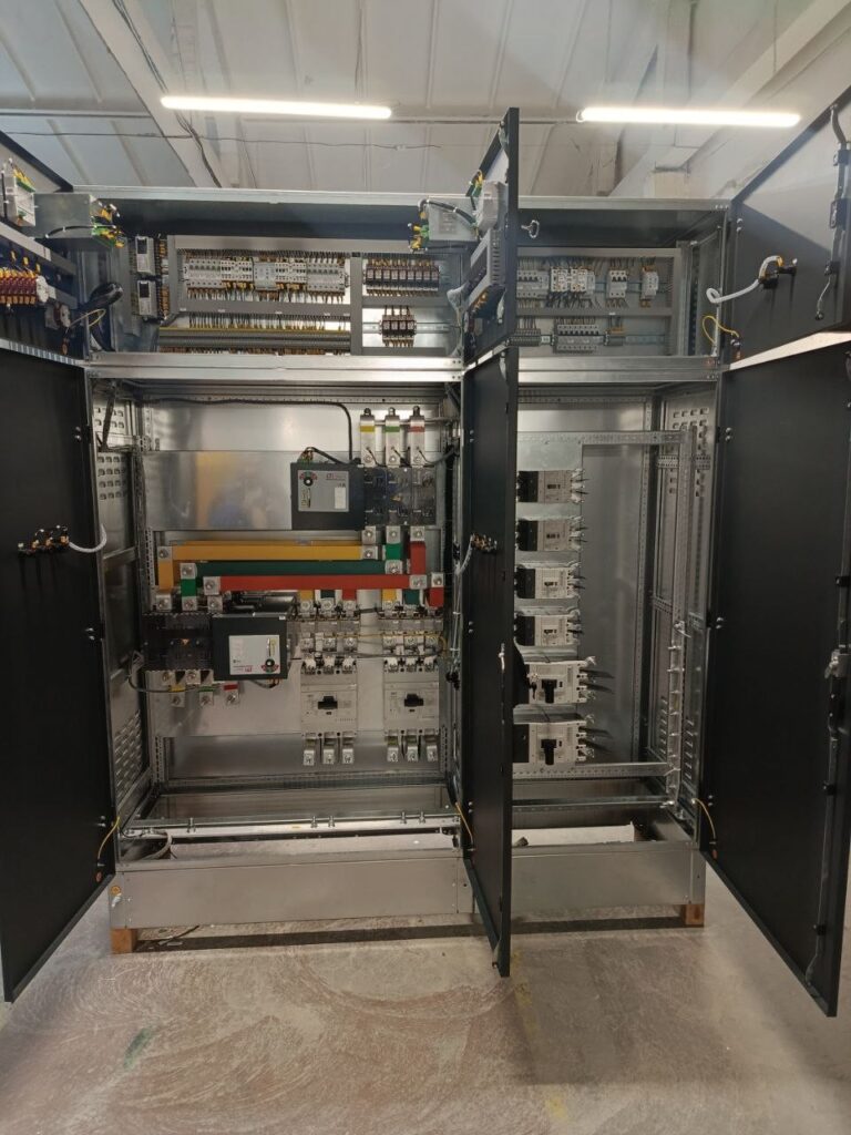 Low-voltage switchgear assembly 0.4 kV with open doors showing busbars and breakers