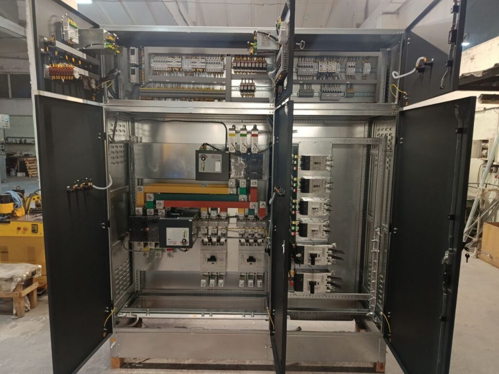 Sections of 0.4 kV low-voltage switchgear with busbars and breakers in workshop