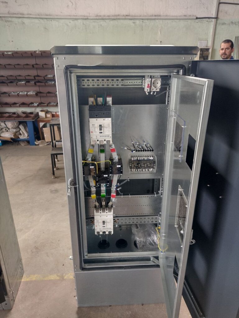 Open floor-standing 0.4 kV cabinet with moulded case circuit breakers during assembly