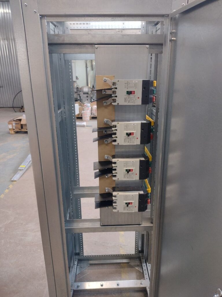Assembly of 0.4 kV distribution board with molded case circuit breakers in workshop