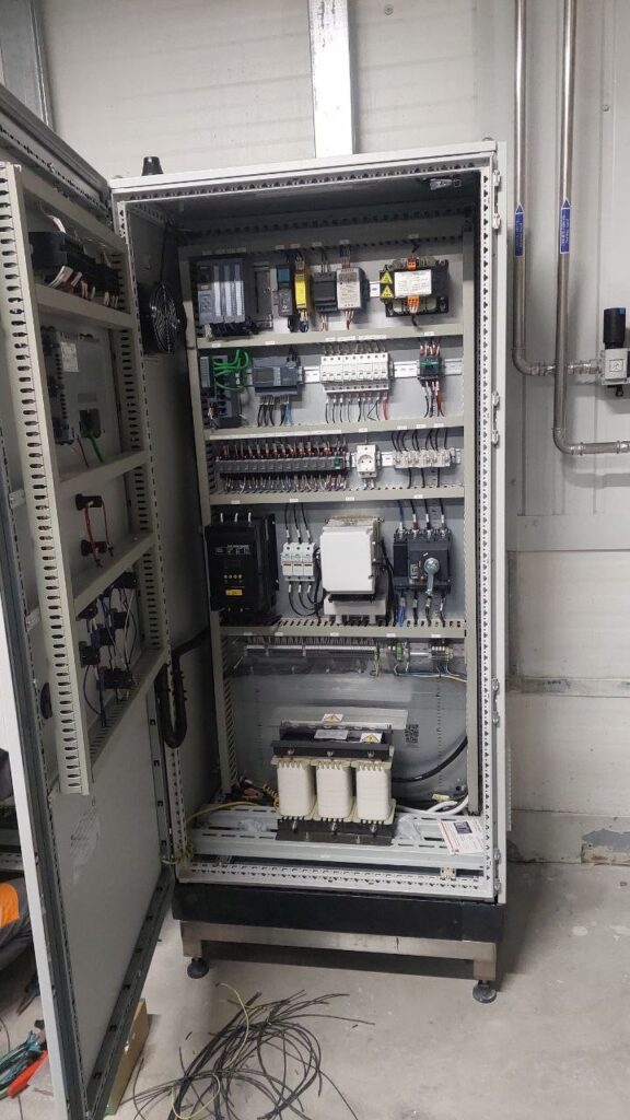 Automatic transfer switch cabinet with PLC and switching components, doors open