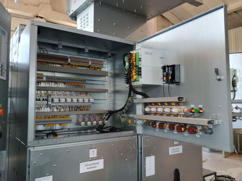 Open secondary wiring compartment of bus section breaker cubicle with terminal blocks