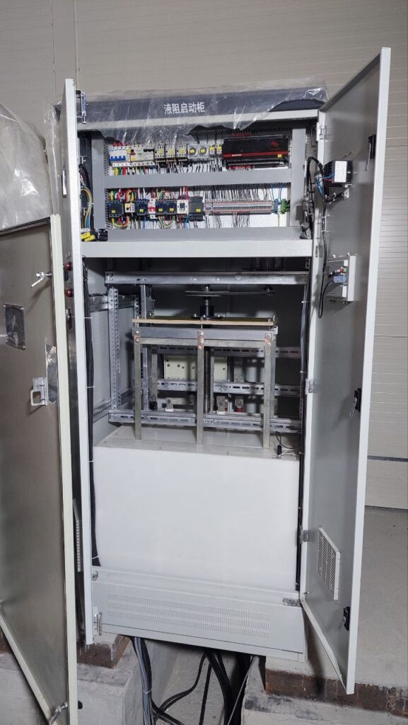 Open liquid starter cabinet showing controller, relays and liquid resistor tank