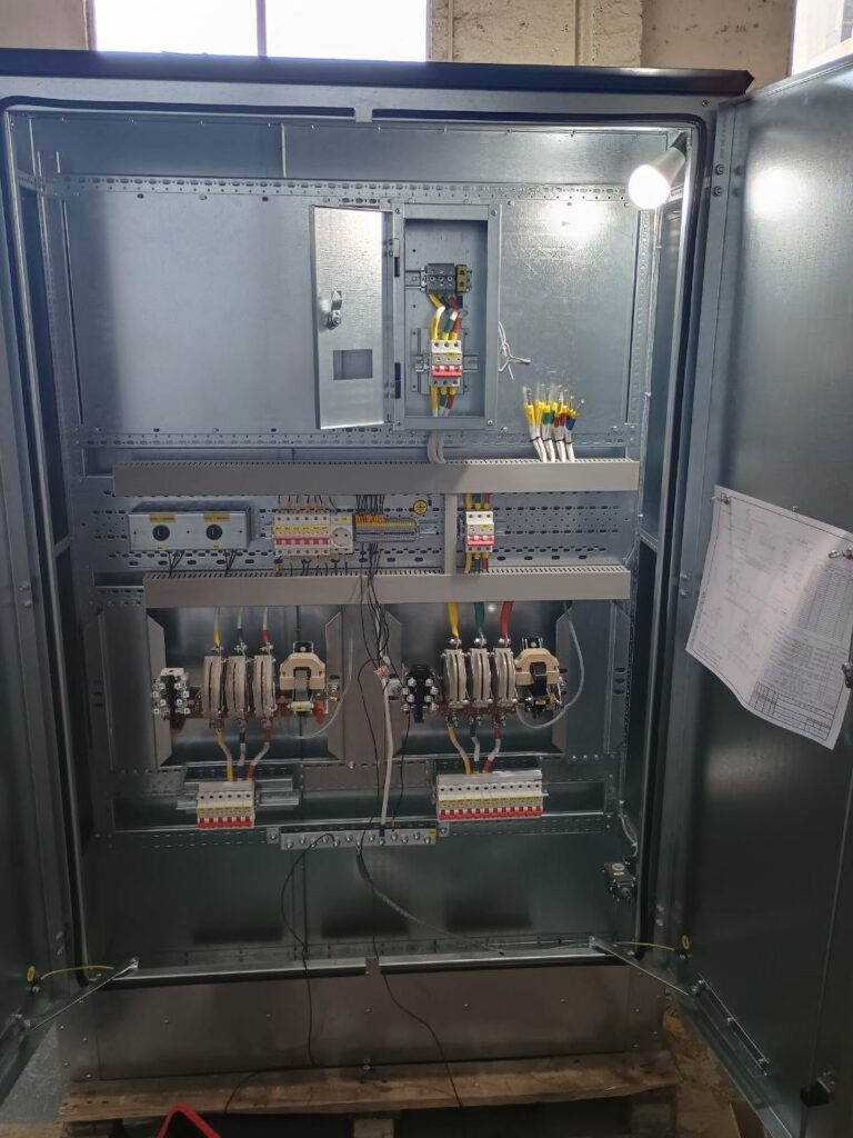 Internal layout of low-voltage control cabinet with contactors and modular circuit breakers