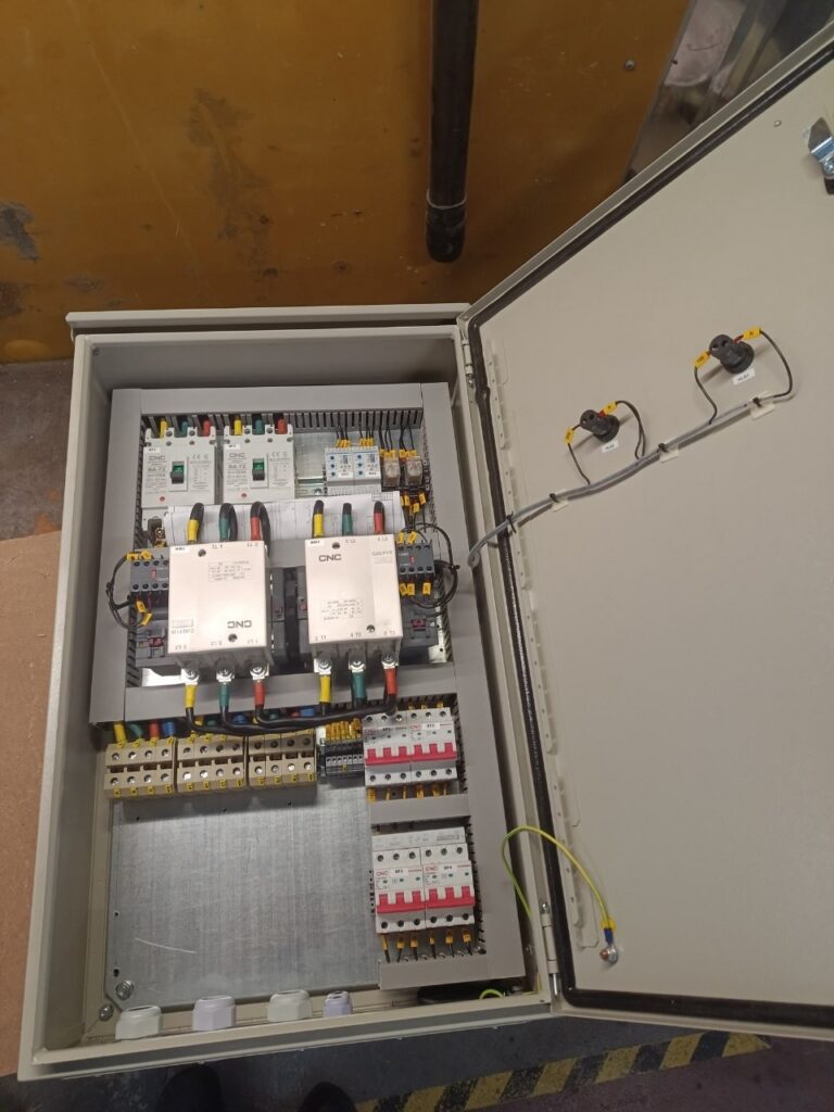 ATS changeover panel interior with two reversing contactors and circuit breakers
