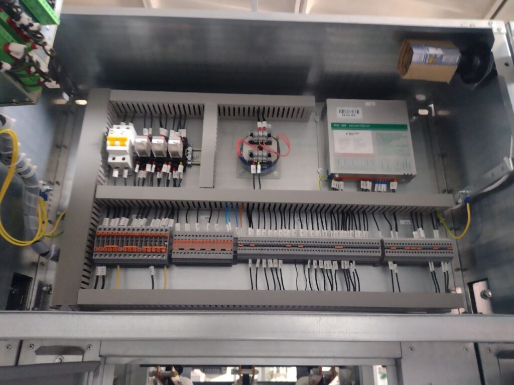 Automation panel assembly with DIN-rail modular devices and rows of terminal blocks