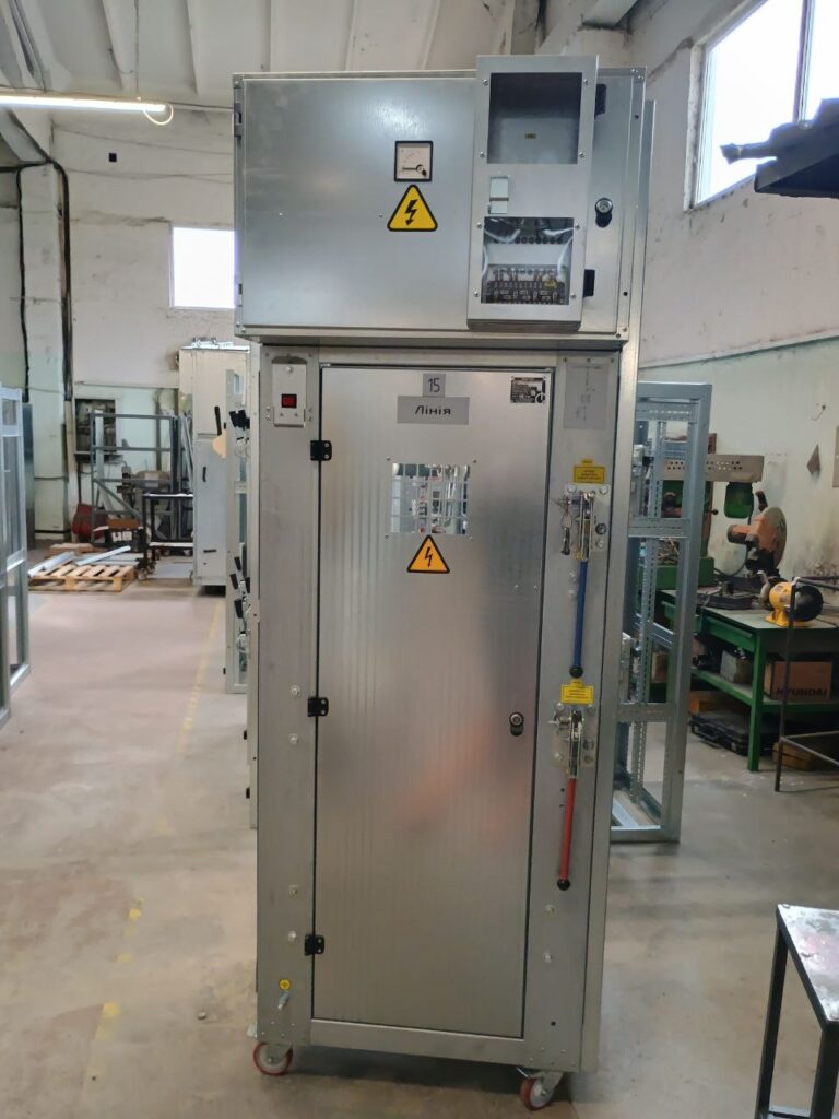 Switchgear cubicle with relay compartment and manual operating drives in production workshop