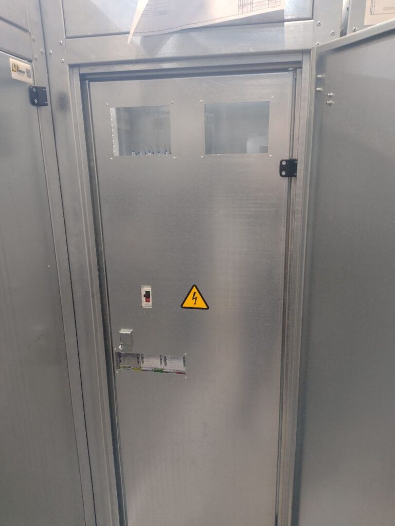 Closed switchboard cabinet with inspection windows on the door